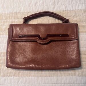 Vintage brown leather clutch with Bakelite/Lucite adornment.